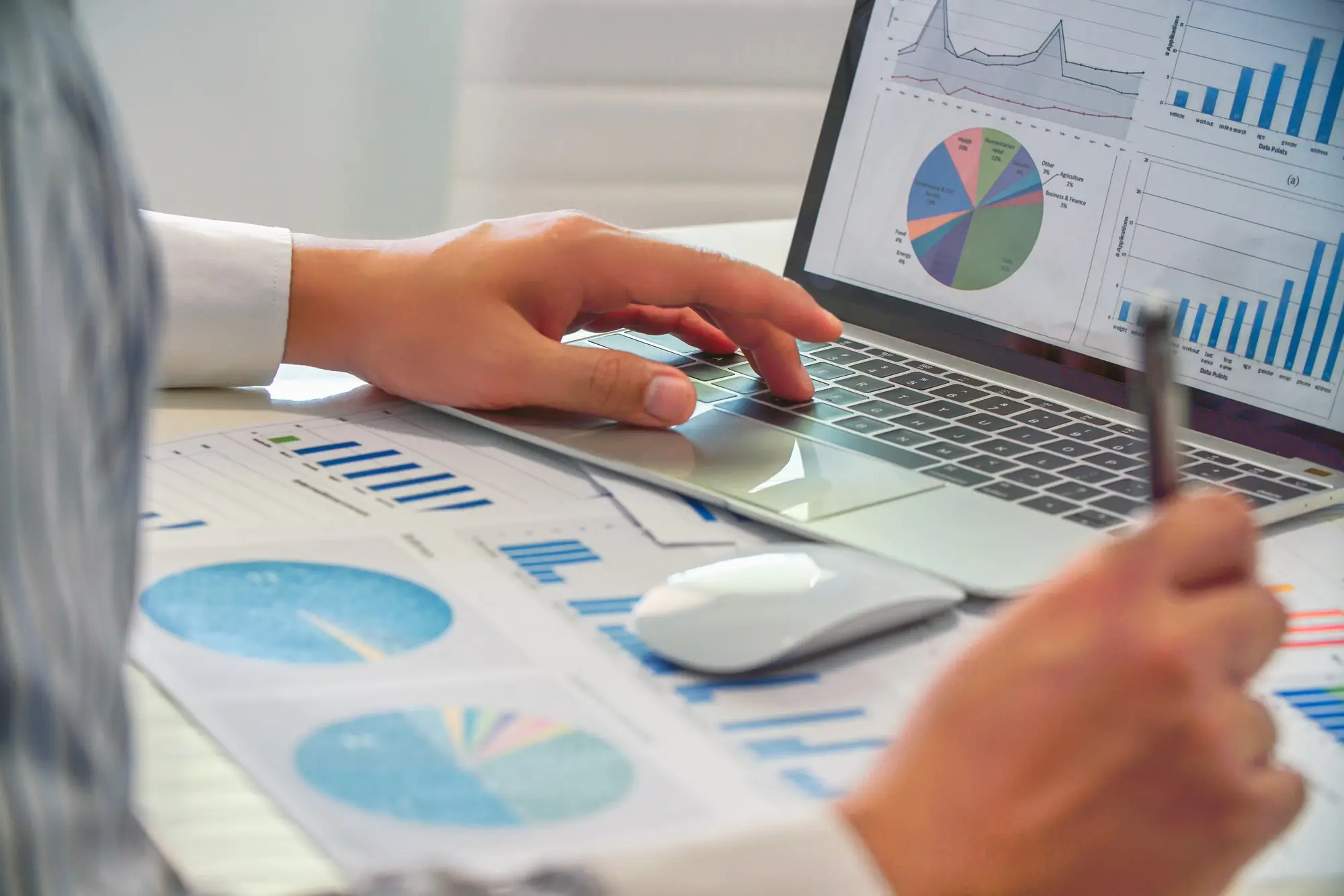 close-up-of-business-people-analysis-charts-and-graphs-of-marketing-on-laptop-and-paperwork